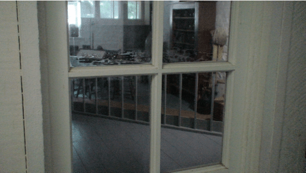 Looking-into-the-kitchen-through-the-door-glass-at-Bellevue-House---Kingston,-Ontario,-Canada